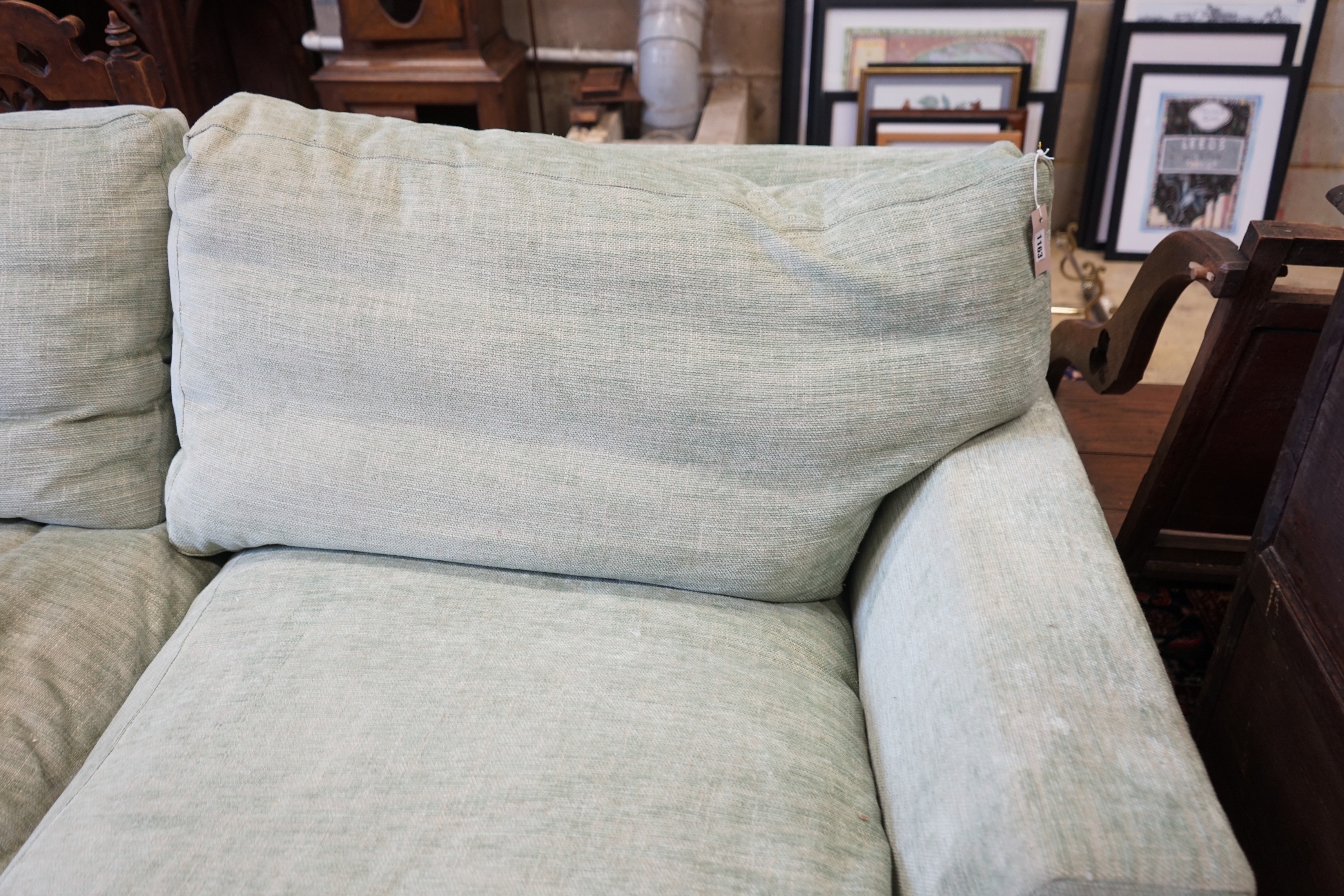 A large Howard style three seater settee upholstered in pale green fabric, length 300cm, depth 120cm, height 92cm